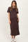 woman wearing a brown short sleeve maternity maxi dress with side pockets and a visible baby bump