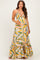 woman wearing a colorful floral print maternity maxi dress with a flared hem and holding her baby bump