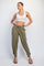 woman wearing a white sports bra and olive green relaxed fit jogger pants with side pockets