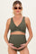 woman wearing an olive green maternity bikini with a V-neck top and high-waisted bottoms, holding her baby bump
