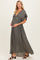 woman wearing a dark olive green maternity maxi dress with ruffle sleeves and button details, showing her baby bump