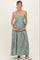 woman wearing a green and white striped maternity maxi dress and holding her baby bump