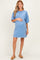 woman wearing a blue short sleeve maternity dress and gently holding her baby bump