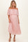 woman wearing a blush pink off-the-shoulder pleated maternity dress with a visible baby bump
