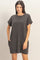 woman wearing a dark gray oversized t-shirt dress with short sleeves and a chest pocket