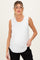 woman wearing a white sleeveless maternity top and holding her baby bump