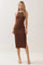 woman wearing a brown ribbed maxi dress with white shoulder straps and side slits