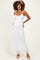 woman wearing a white lace maternity maxi dress and showing her baby bump