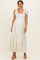 woman wearing a white floral maxi maternity dress with tie straps and a visible baby bump