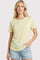 woman wearing a light yellow striped short sleeve t-shirt and denim shorts