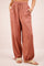 woman wearing terracotta drawstring cargo pants with side pockets and elastic cuffs