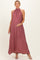 woman wearing a flowy dusty rose maternity maxi dress with a halter neck and holding her baby bump