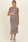 woman wearing a brown and white striped maternity dress with side slits and holding her baby bump