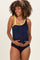 woman wearing a navy ribbed maternity swimsuit with colorful straps and a baby bump visible