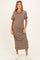 woman wearing a striped brown maternity dress with short sleeves and scalloped neckline, showing her baby bump