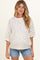 woman wearing a cream floral print maternity sweatshirt with short sleeves and a relaxed fit, showing her baby bump
