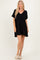 woman wearing a black short sleeve swing dress with a v-neck and relaxed fit