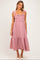 woman wearing a red and white gingham maternity dress with ruffled straps and a tiered hem