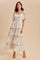 woman wearing a pastel yellow tiered maxi dress with floral print and puff sleeves