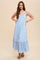 woman wearing a light blue floral maxi dress with button details and ruffled hem