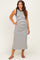 woman wearing a black and white striped maternity maxi dress with a fitted style and side slits, showing her baby bump