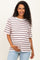 woman wearing a striped maternity t-shirt in white, red, and blue, holding her baby bump with a smile