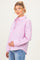 woman wearing a pink striped maternity shirt with a front pocket and holding her baby bump