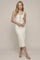 woman wearing a cream ribbed midi dress with button details and black trim, standing against a neutral background