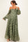 woman wearing a green lace off-shoulder maternity dress with long sleeves and a flowy skirt