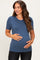 woman wearing a blue short sleeve maternity top and holding her baby bump