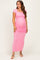 woman wearing a pink maternity maxi dress with short sleeves and ruching, showcasing her baby bump