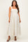 woman wearing a white floral maternity dress with a square neckline and flowy skirt