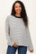 woman wearing a striped black and white maternity sweater with long sleeves and a relaxed fit, holding her baby bump