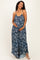woman wearing a navy blue floral maternity maxi dress and holding her baby bump