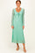 woman wearing a light green long sleeve maxi dress with a tie front and textured lace detail