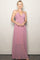 woman wearing a light pink halter maxi dress with a gathered bodice and flowing skirt