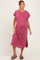 woman wearing a rose-colored ribbed maternity dress with short sleeves and side slits