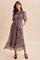 woman wearing a floral patterned maxi dress with short sleeves and pockets, styled with black flats