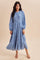 woman wearing a light blue long sleeve floral maxi dress with puff sleeves and a flowing skirt