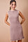 woman wearing a ribbed mauve sleeveless mini dress with white trim details