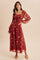 woman wearing a burgundy long sleeve floral maxi dress with a square neckline and gathered detail at the waist
