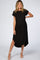 woman wearing a black maternity maxi dress with short sleeves and a high-low hem, showing her baby bump