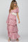 woman wearing a pink floral maternity dress with tiered ruffles and puff sleeves, showcasing her baby bump