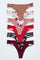 Collection of strappy thong underwear in solid colors and floral prints arranged on a white background