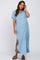 woman wearing a light blue maternity button-up dress with short sleeves and a side slit, showing her baby bump