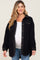 Pregnant woman wearing a black sherpa maternity shacket over a white top and blue jeans