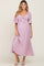 woman wearing a lavender maternity dress with a tie front and flutter sleeves, showing her baby bump