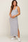 woman wearing a gray and white striped maternity maxi dress with side slits and holding her baby bump