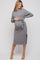 woman wearing a gray ribbed maternity dress with a tie waist and side slit, showcasing her baby bump