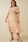 Woman wearing a plus size orange and white floral midi dress with smocked bodice and tiered skirt
